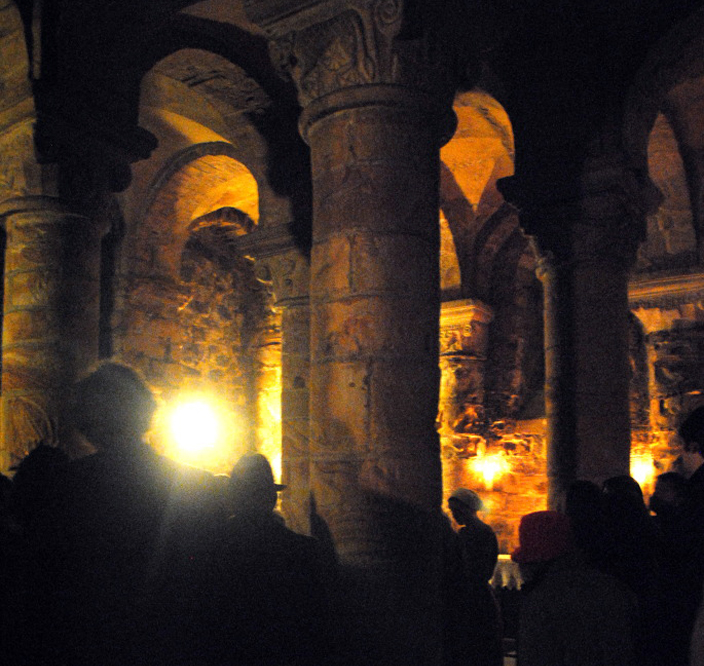 The squarish space of the Norman Chapel lends itself to a variety of uses. Still used as a place of worship, it is also a popular venue for performances and concerts where an intimate historic setting is desirable. Here, audience members watch 1072 a Durham Student Theatre performance about the World Heritage Site unfold.  